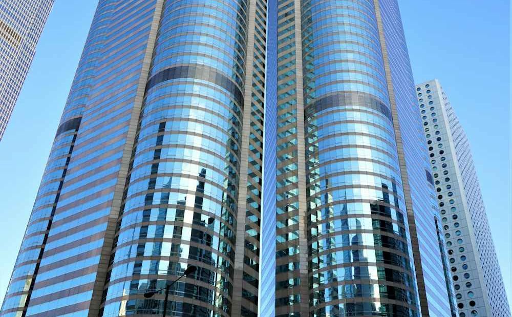Glass towers rising into a clear blue sky